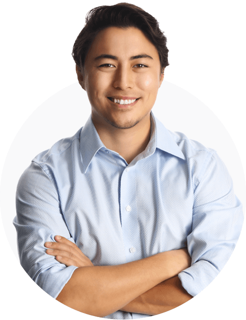 A professional looking man looking at the camera, smiling, with his arms crossed.