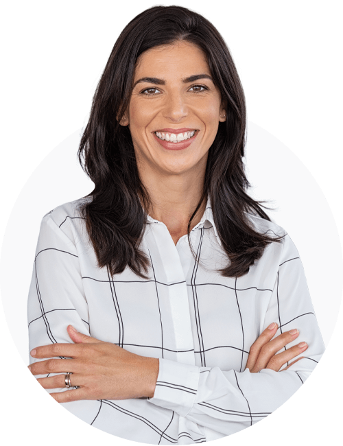 A professional looking woman in white shirt with her arms crossed, smiling into the camera.